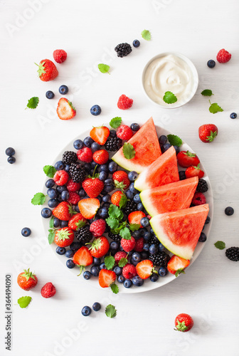 fruit and berry platter over white. blueberry, strawberry, raspberry, blackberry, watermelon