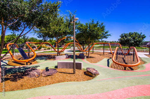 Photography Unique Curved Orange Playground Equipment In Public Park
