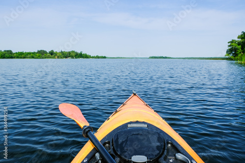 Kayaking on a lake. Paddle lying on kayak. © Iryna Liveoak