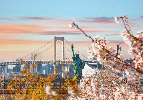 Replica of the french with cherry blossoms in the Odaiba Seaside Park in front of the double-layered suspension Rainbow Bridge in Tokyo bay. photo