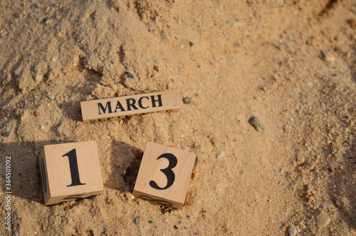 March 13, Number cube with Sand pile for a background.