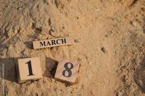 Foto March 18, Number cube with Sand pile for a background.
