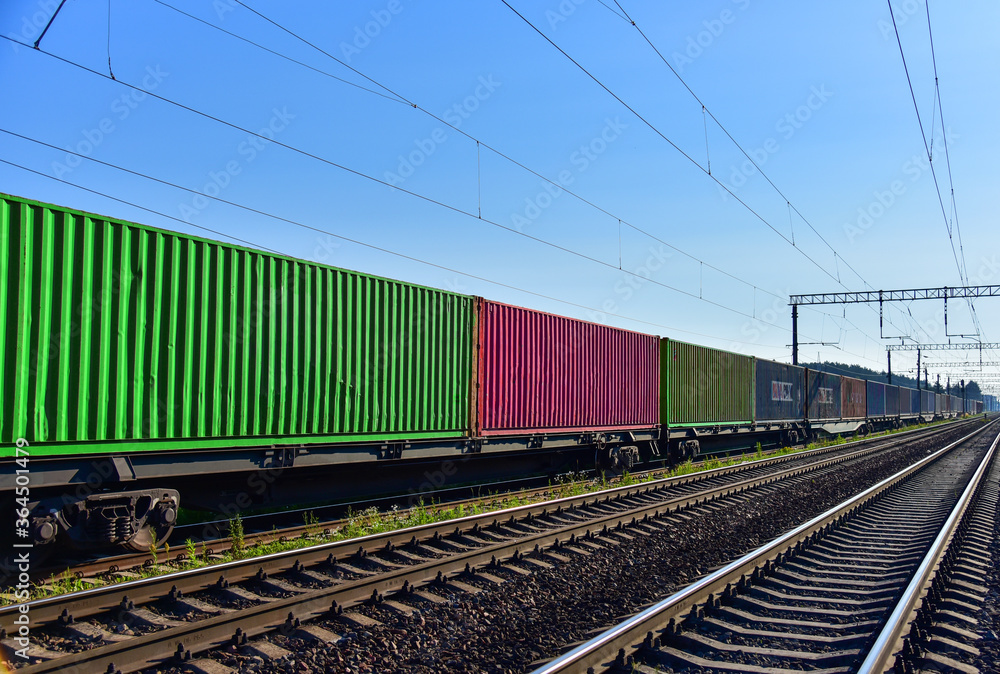 Fototapeta premium Cargo Containers Transportation On Freight Train By Railway. Intermodal Container On Train Car. Rail Freight Shipping Logistics Concept. Import - export goods from Сhina.