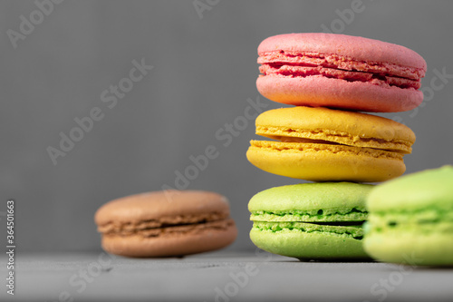 Fototapeta Naklejka Na Ścianę i Meble -  Colorful macaroon cookies on grey surface close up