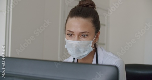 physician face looking at office monitor