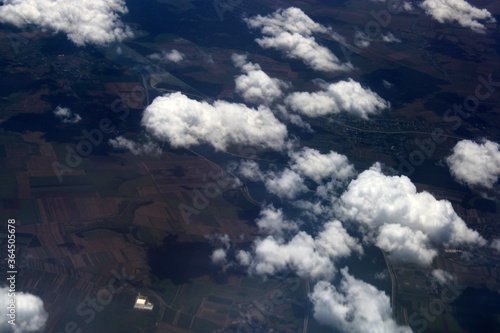 Bild auf Leinwand Aerial view of the countryside from above the clouds