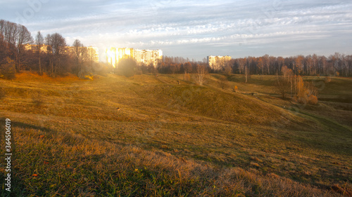 delightful landscape of a hilly field at sunset. Tsaritsyno city Park in Moscow in the soft sun lights