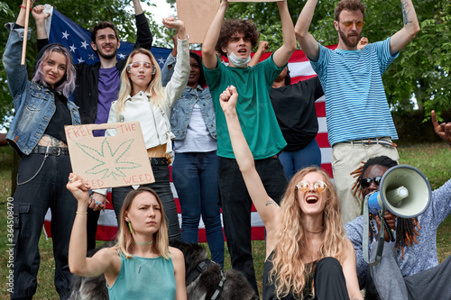 international group of young people holding broadsheets demanding legalization of marijuana, cannabis photo