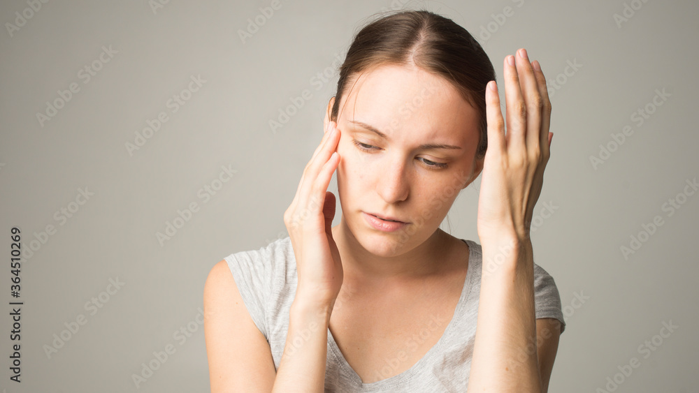 Fototapeta premium Young beautiful woman has headache