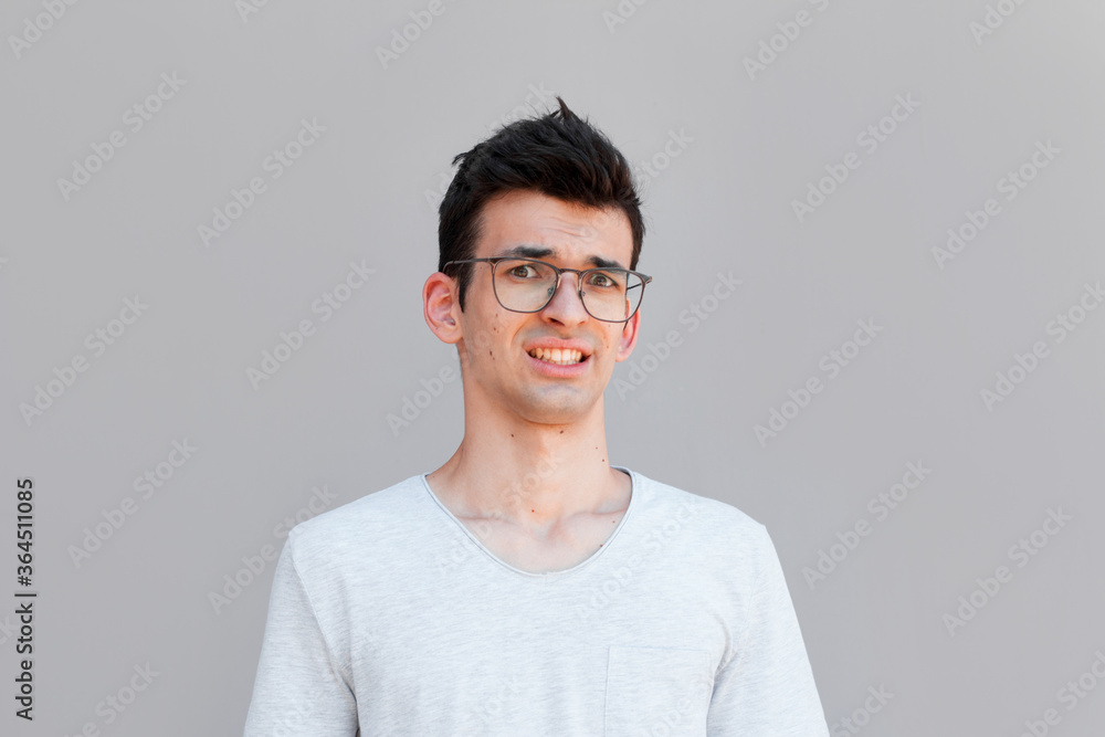 Close up of a doubtful young man Close up of a doubtful young man