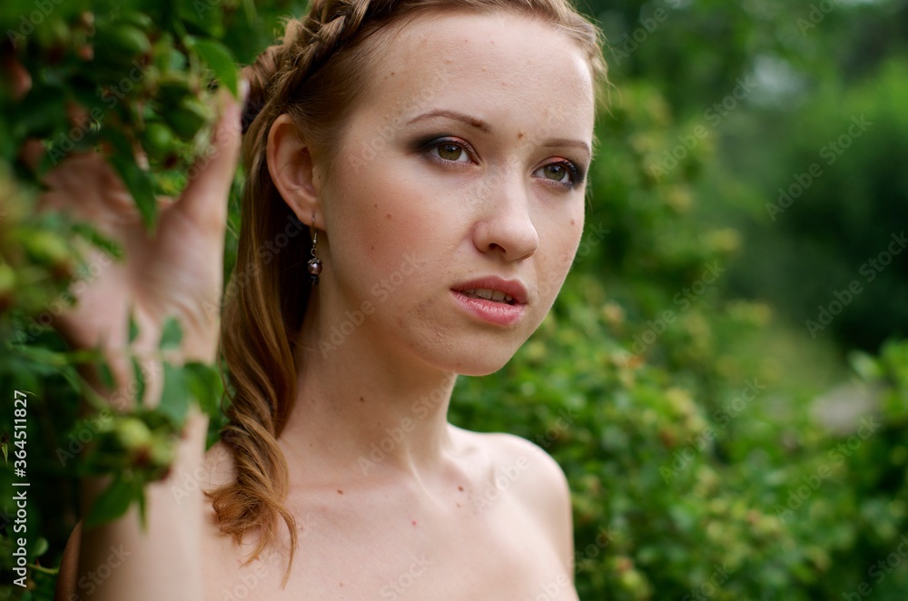 The beautiful girl is walking outdoors. Girl in the park. Girl on nature. Woman outside. Positive woman smiling The beautiful girl is walking outdoors. Girl in the park. Girl on nature. Woman outside. Positive woman smiling