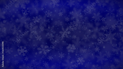 Christmas background of snowflakes of different shapes, sizes, blur and transparency in blue colors