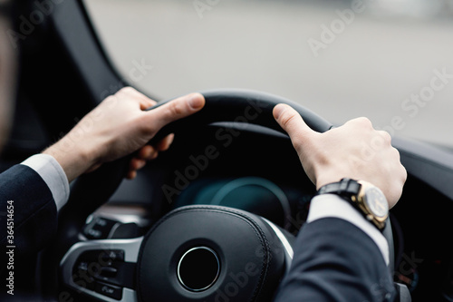 Unrecognizable businessman driving alone in his new car © Prostock-studio