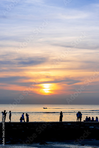 Early morning sunset / sunrise with Vew of volcano Agung mountains of Bali and sea and beach, Bali, Indonesia. Azure beach, rocky mountains in ocean in morning background