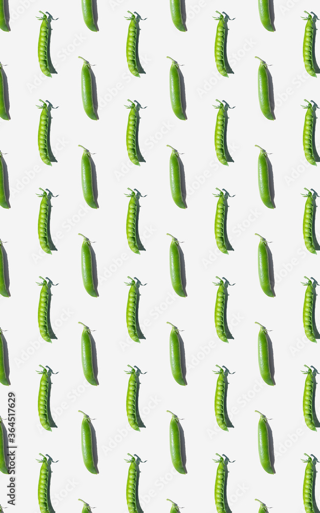 Pattern of peas in pods on a light background. The concept of healthy vitamin food, detail, crop, vegetarianism. Pattern of peas in pods on a light background. The concept of healthy vitamin food, detail, crop, vegetarianism.