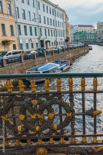 Decorative fence of Great Konyushenny Bridge above Moika River. Saint Petersburg, Russia photo