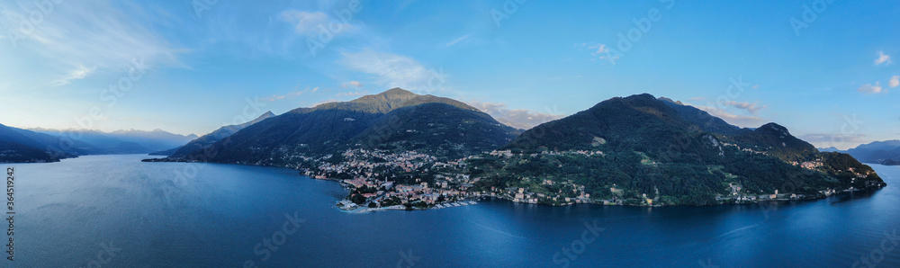 aerial panorama of italian village by lake