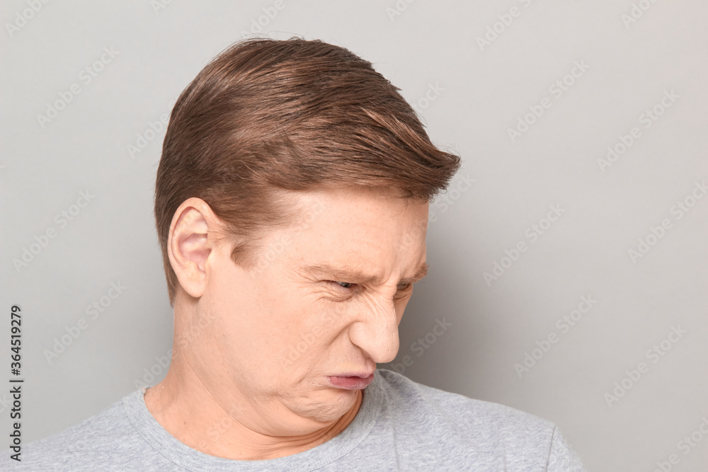 Portrait of funny man grimacing from disgust and squeamishness Portrait of funny man grimacing from disgust and squeamishness