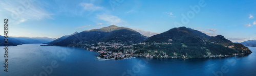 aerial panorama of italian village by lake