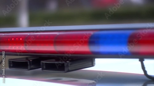 Flashing red light on the police car with blurred background.