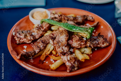 Spanish pork meat with potatoes in a typical Andalusian town restaurant