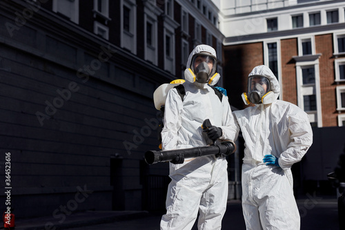 portrait of professional fearless cleaning service outdoors. disinfectors clean the territory in city, prevent covid-19 bacterias and infection