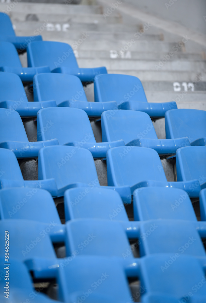 Fototapeta premium Empty soccer stadium tribune. As a safety measure during corona virus pandemic, soccer matches are taking place without public