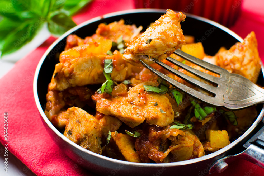 Chicken, tomato and zucchini sauce served with rice.