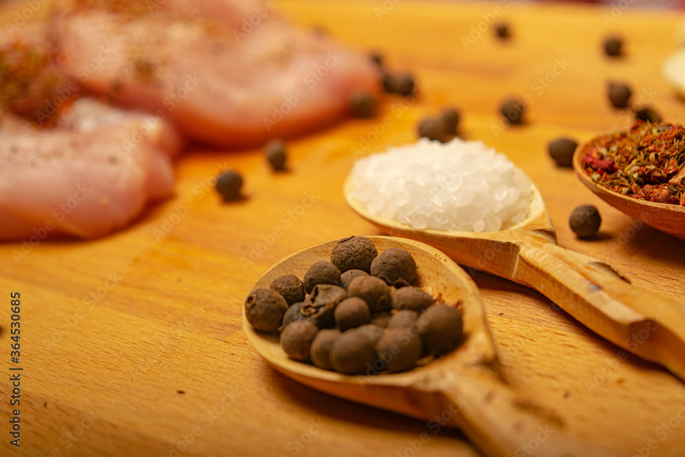 Meat steaks and various spices on a wooden Board. Close up. Meat steaks and various spices on a wooden Board. Close up.