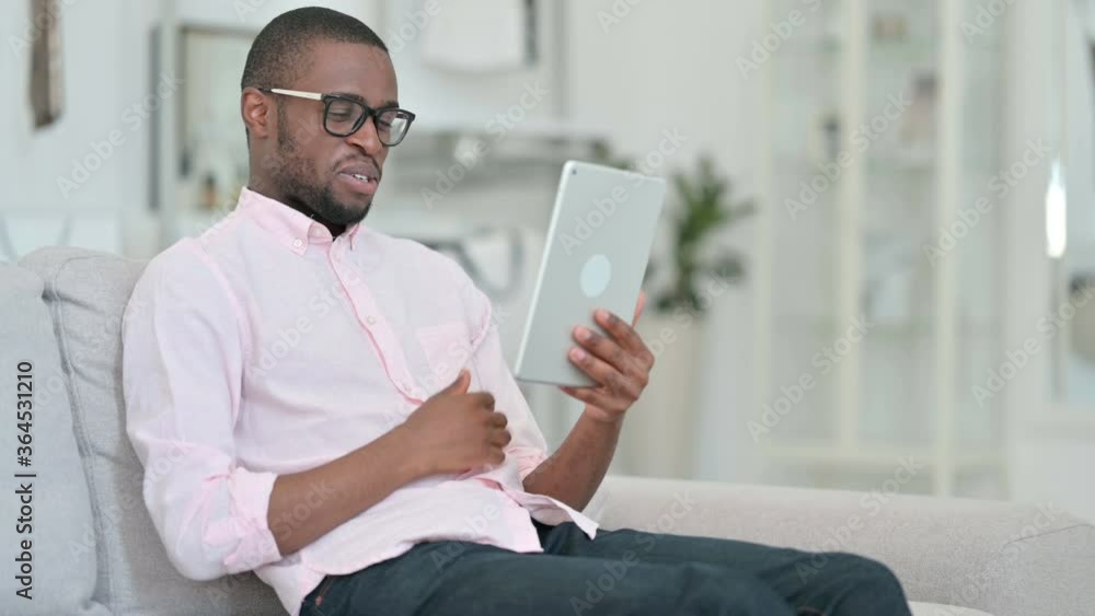 Young African Man doing Video Call on Tablet at Home Young African Man doing Video Call on Tablet at Home
