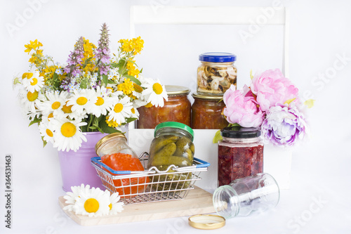 Glass jars with jam and pickles.