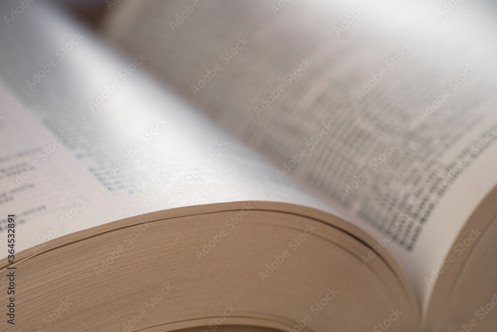 Open book with the atmosphere of religion. The text is not readable Open book with the atmosphere of religion. The text is not readable