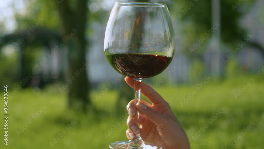 Glass of wine in the woman's hand