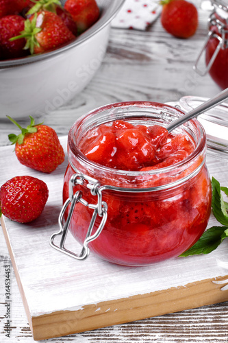 Wallpaper Mural Strawberry jam in glass jar on the white wooden table. Berries around Torontodigital.ca