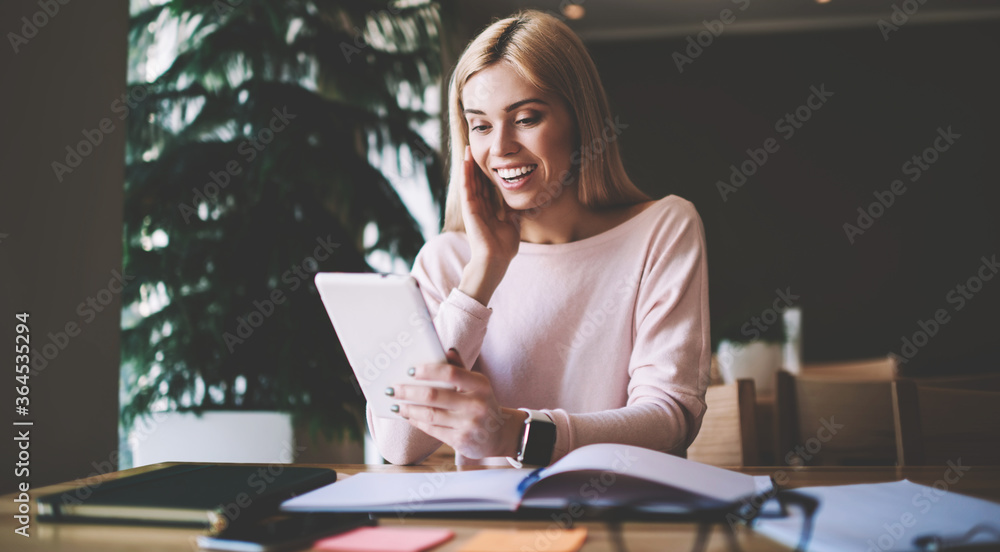 Shocked young woman received message on gadget about upcoming discounts in favorite web store, emotional hipster girl surprised with news for tomorrow examination sitting in university classroom Shocked young woman received message on gadget about upcoming discounts in favorite web store, emotional hipster girl surprised with news for tomorrow examination sitting in university classroom