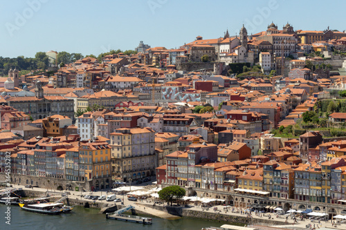 Colorful houses of Porto Ribeira, traditional facades, old multi-colored houses with red roof tiles on the embankment in the city of Porto, Portugal. Unesco World Heritage site. © An Instant of Time