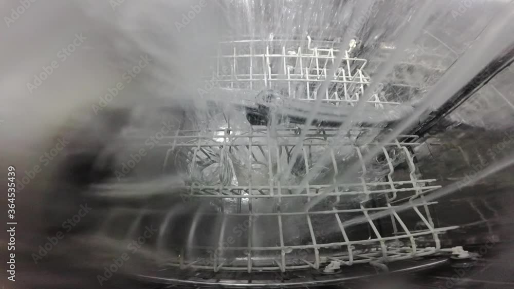 Slow motion. The master repairs the dishwasher and checks the operation