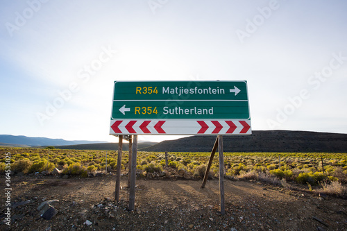 Wide Angle view of a road sign on the highway in the Tankwa Karoo, pointing out the direction to the two towns, Matjiesfontein and Sutherland