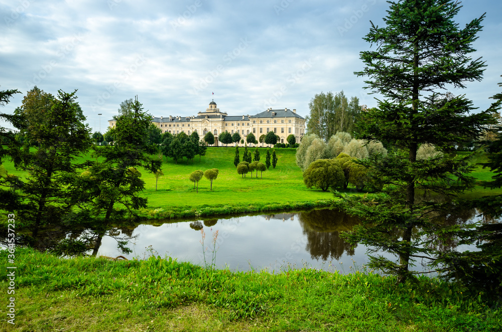Fototapeta premium Country cottage with a large green summer garden. Beautiful summer landscape landscape park. Nature for background on postcard.