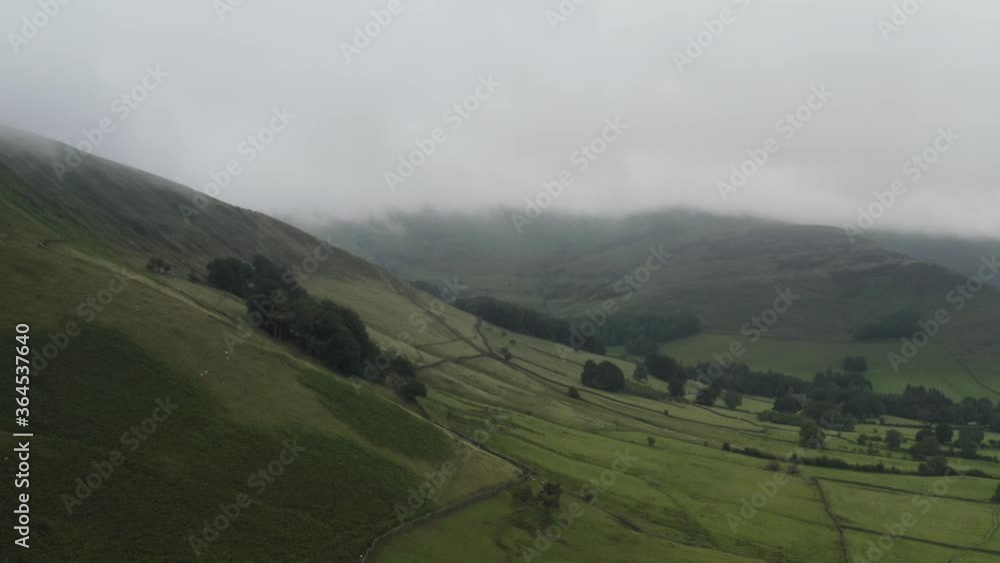 Cloudy Peak District aerial shot over fields of green farmland Cloudy Peak District aerial shot over fields of green farmland