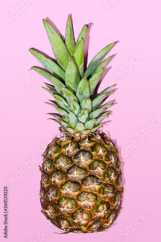 Fresh pineapple on a pastel pink background. Summer concept. Flat lay, top view