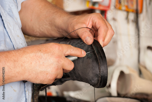 Shoemaker, stitching of the shoe