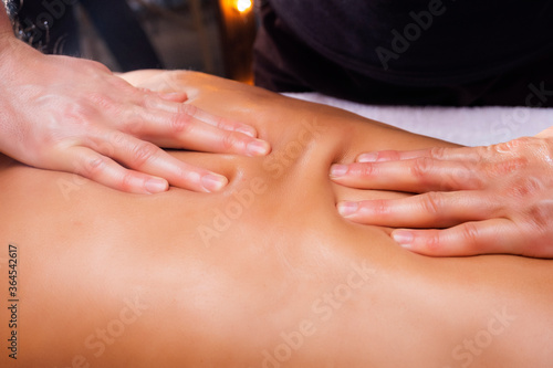 Photo of a back massage from above. Therapeutic massage close-up. Massage the back and neck.