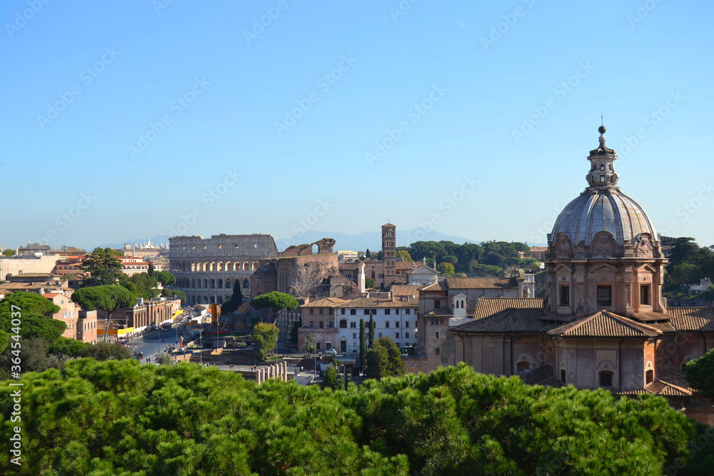 overview of old rome with ancient roman ruins, roman forum and colosseum in the back
