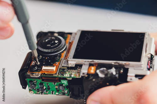 Фотография Repairing digital single lens reflex camera, isolated.