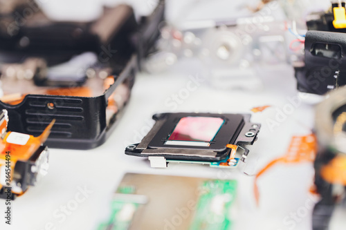 Engineer and technician Minitures are fixing camera mirror box assembly , Miniture workers are checking optics and carry out maintenance and cleaning of the broken camera at the service center. photo