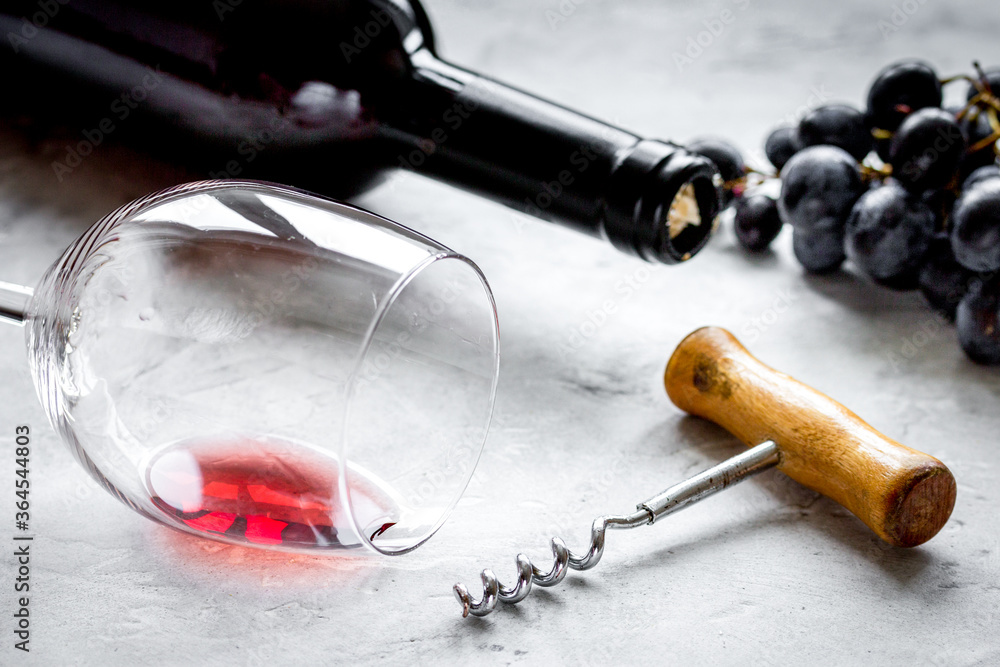restaurant set with wine bottle and grape on stone background restaurant set with wine bottle and grape on stone background