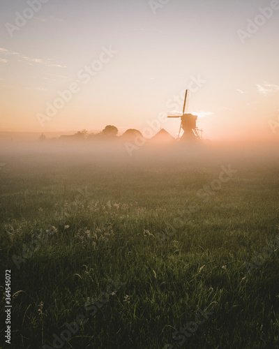 Fotografie windmill in the morning-mist in holland