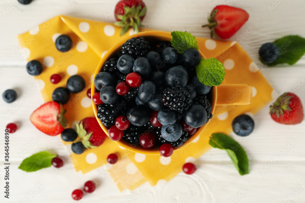 Composition with cup of fresh berries on wooden background, top view Composition with cup of fresh berries on wooden background, top view