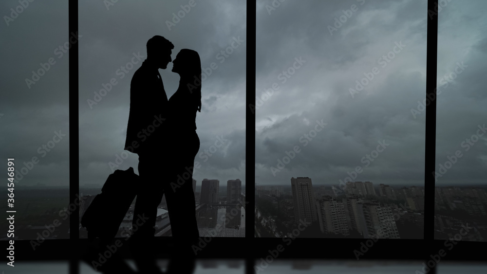 The romantic couple standing in the big hall with a beautiful sky view
